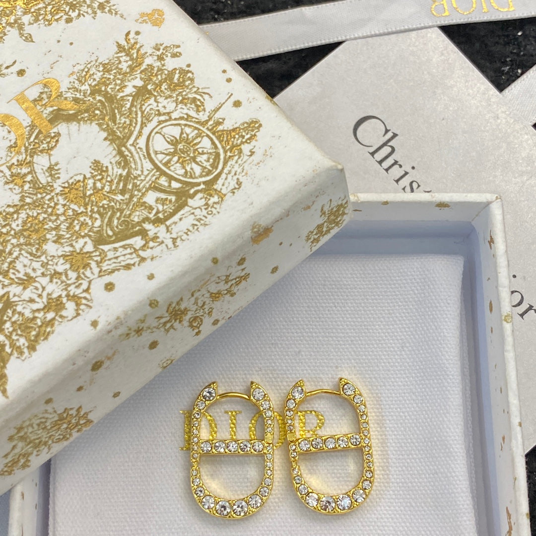CD 26S CRYSTAL LOGO STUD EARRINGS IN GOLD TONE METAL 646502