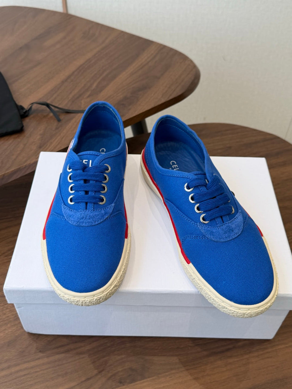 CELINE 26S TRIOMPHE LOW TOP SNEAKERS IN BLUE CANVAS RED TRIM