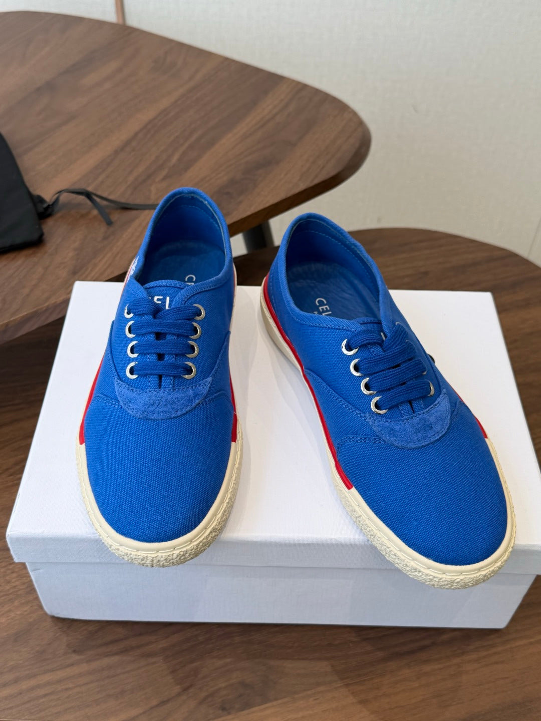 CELINE 26S TRIOMPHE LOW TOP SNEAKERS IN BLUE CANVAS RED TRIM