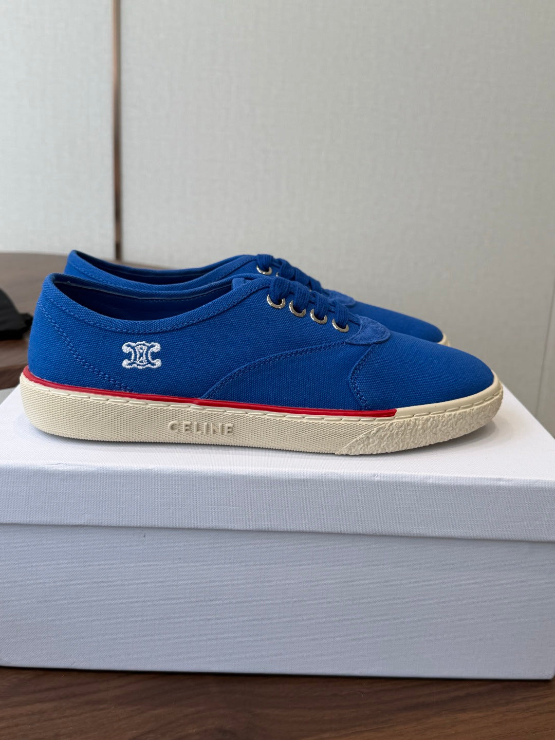 CELINE 26S TRIOMPHE LOW TOP SNEAKERS IN BLUE CANVAS RED TRIM