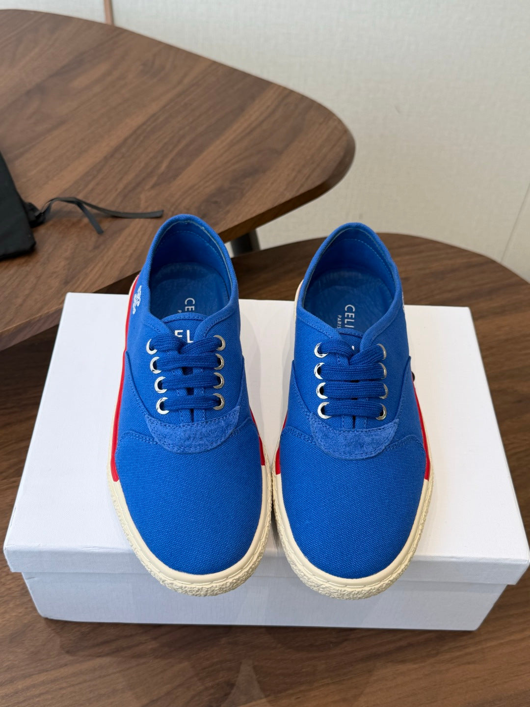 CELINE 26S TRIOMPHE LOW TOP SNEAKERS IN BLUE CANVAS RED TRIM
