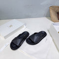 THE ROW 26S CROSS STRAP SLIDES IN BLACK CALFSKIN