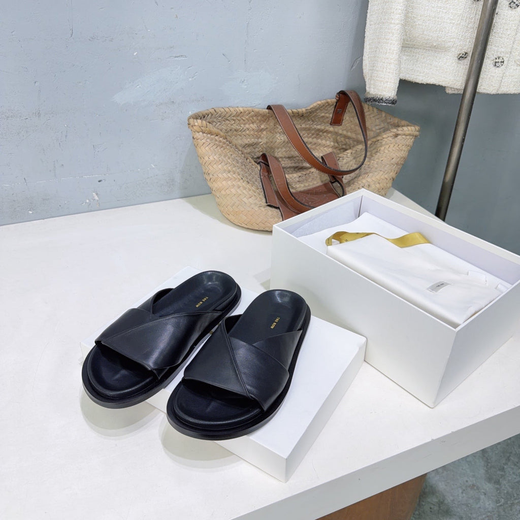 THE ROW 26S CROSS STRAP SLIDES IN BLACK CALFSKIN