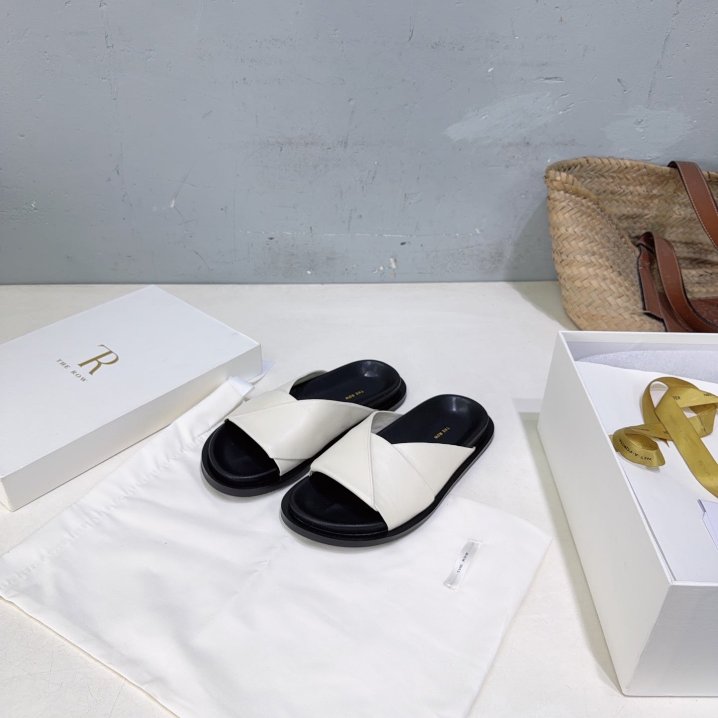 THE ROW 26S CROSS STRAP SLIDES IN IVORY WHITE CALFSKIN WITH BLACK FOOTBED