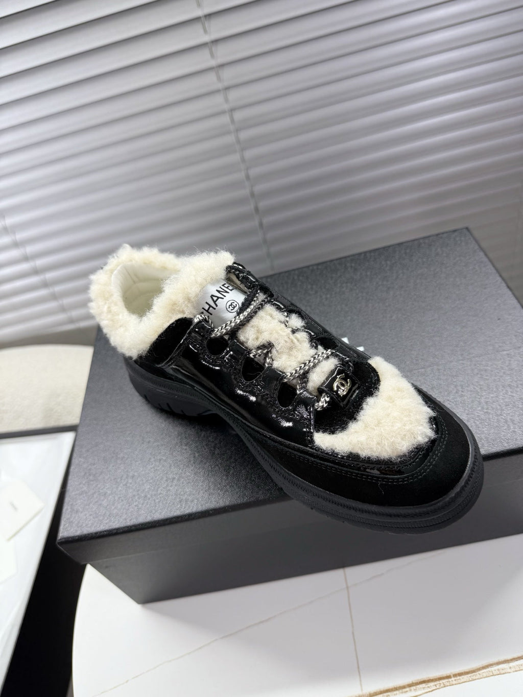 CHANEL 25S SNEAKERS WITH FUR ACCENTS 35MM IN BLACK CALFSKIN