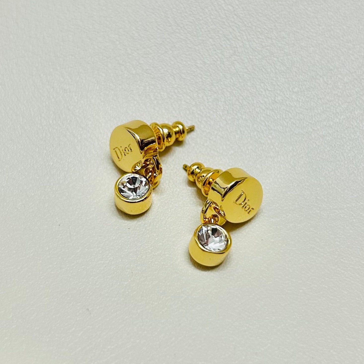 CD 26S CRYSTAL DROP LOGO STUD EARRINGS IN GOLD TONE METAL 646613