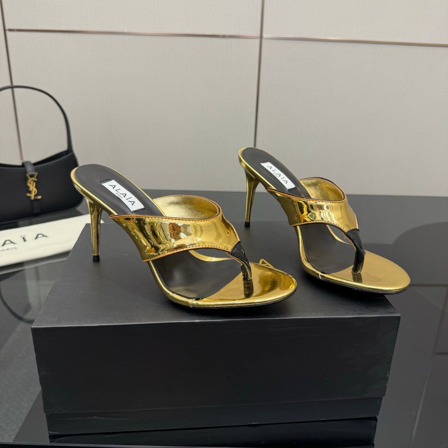 ALAIA HEELED THONG 25S IN GOLD PATENT LEATHER
